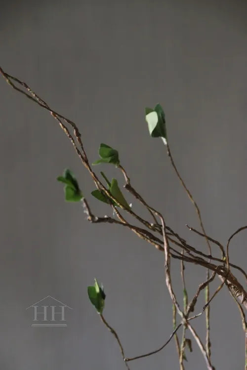 Artificial branch with green leaves