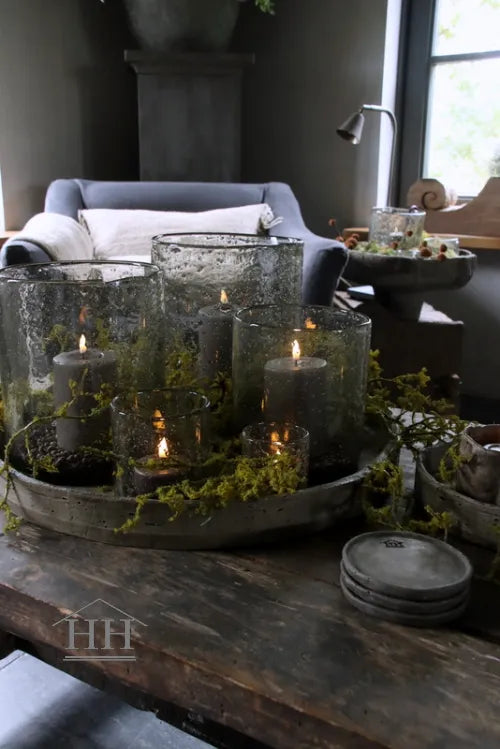 Kunst mostak op betonnen schaal met windlichten