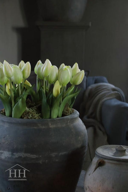 Artificial tulips in white pot