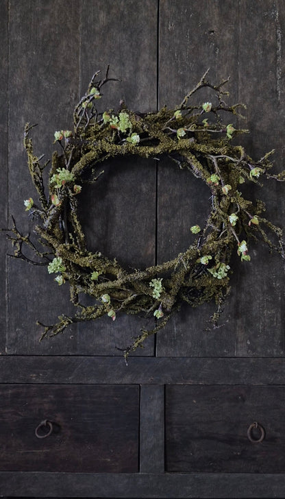 Künstlicher Mooskranz mit weißen Blütenzweigen